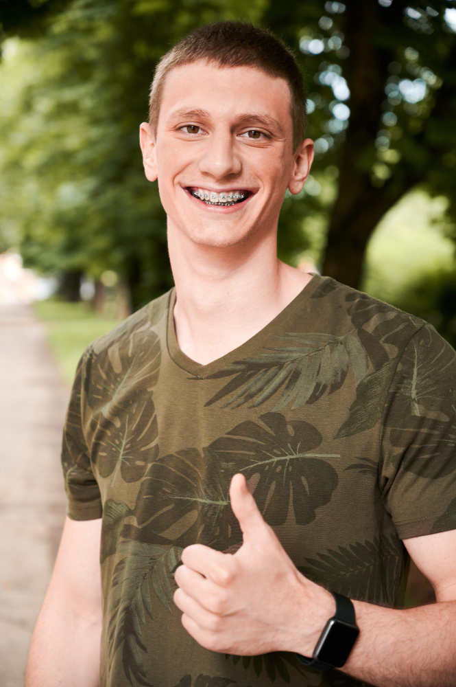 Adult consulting orthodontist about braces treatment options in Queens NY clinic