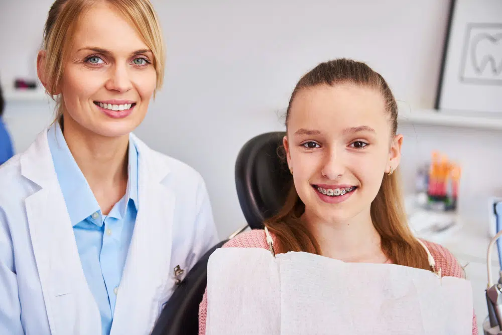 Orthodontist consulting with patient about braces treatment options in Queens NY clinic